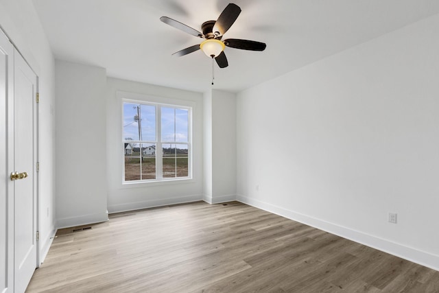 unfurnished bedroom with ceiling fan and light hardwood / wood-style floors