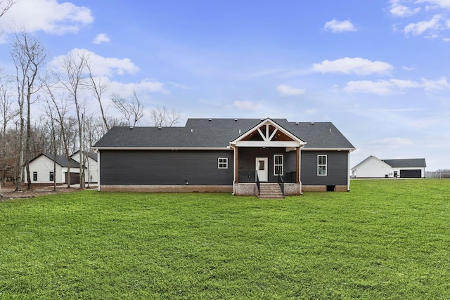 rear view of property featuring a yard