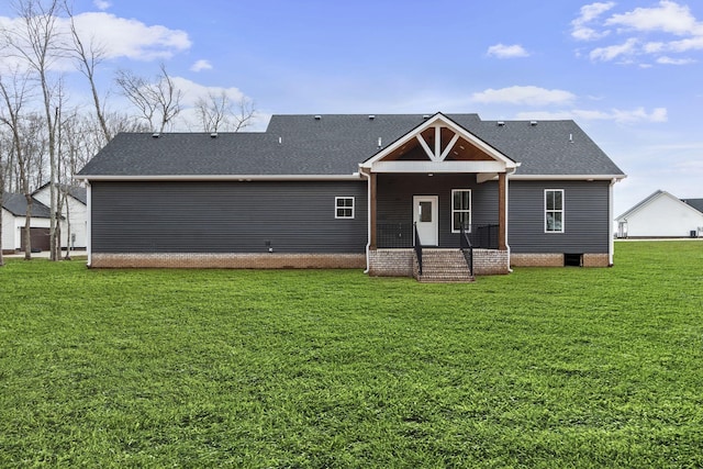 back of property featuring a lawn