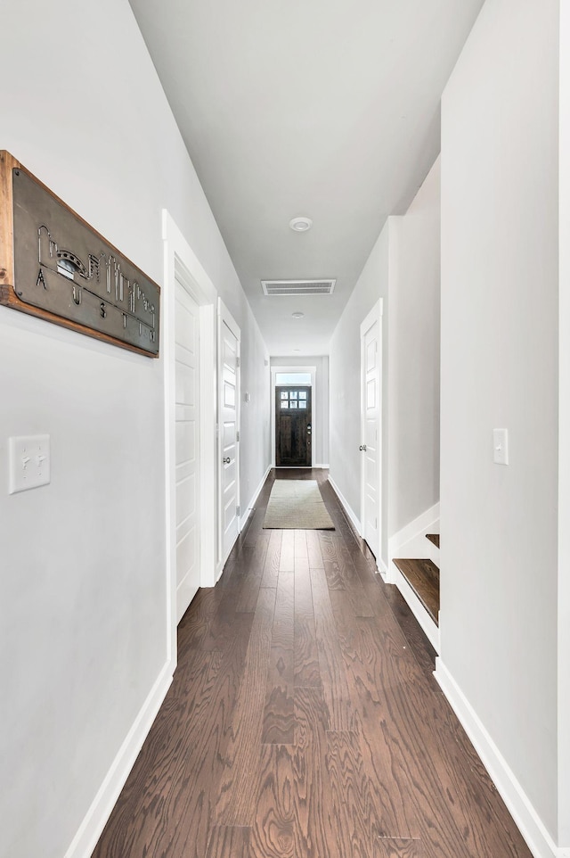 hall with dark hardwood / wood-style flooring