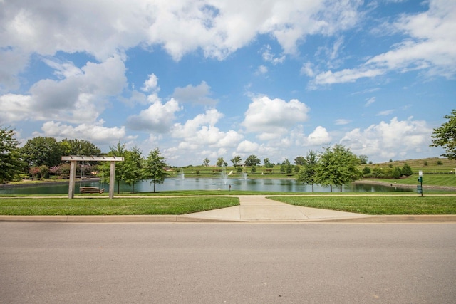 view of property's community featuring a water view and a lawn