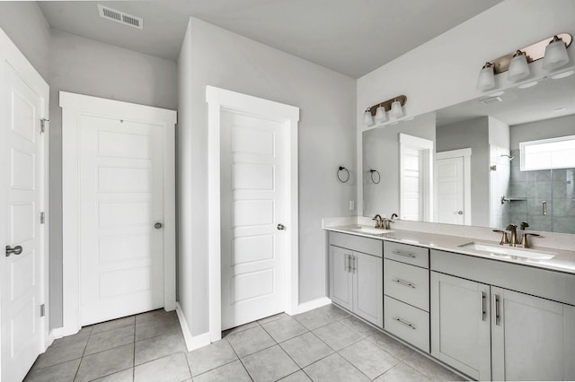 bathroom featuring tile patterned flooring, vanity, and walk in shower