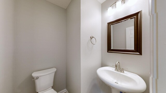 bathroom featuring toilet and sink