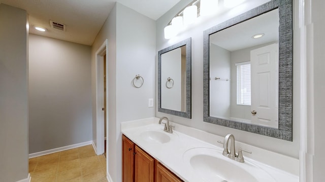 bathroom featuring tile patterned flooring and vanity