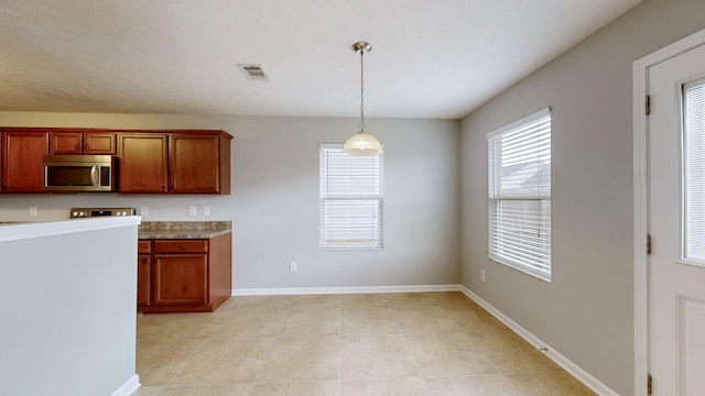 kitchen with a textured ceiling and hanging light fixtures