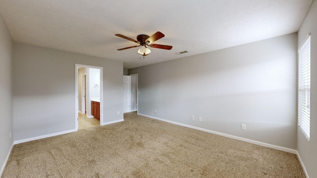 unfurnished bedroom featuring multiple windows, ceiling fan, and light colored carpet