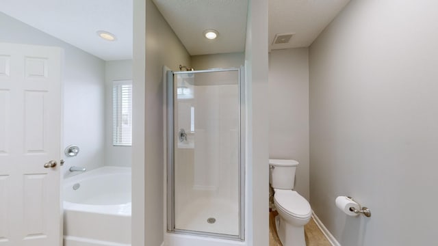 bathroom featuring a textured ceiling, toilet, and independent shower and bath