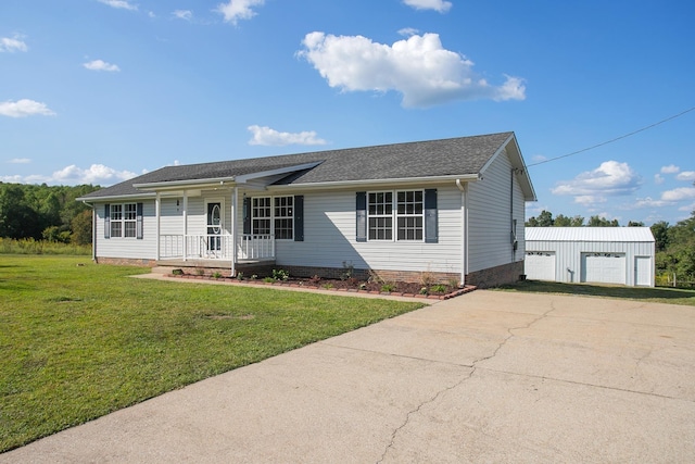 ranch-style home with an outbuilding, a porch, a garage, and a front lawn