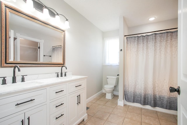 bathroom with tile patterned flooring, vanity, curtained shower, and toilet