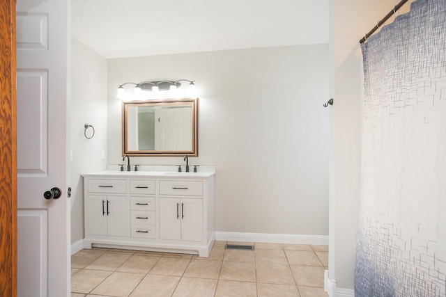 bathroom featuring tile patterned floors and vanity