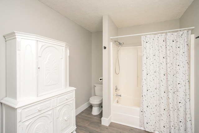 bathroom with shower / tub combo with curtain, wood-type flooring, a textured ceiling, and toilet