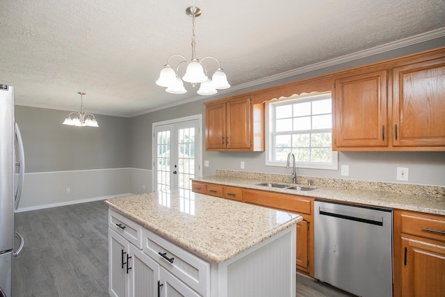 kitchen with a notable chandelier, wood-type flooring, white cabinetry, and stainless steel appliances