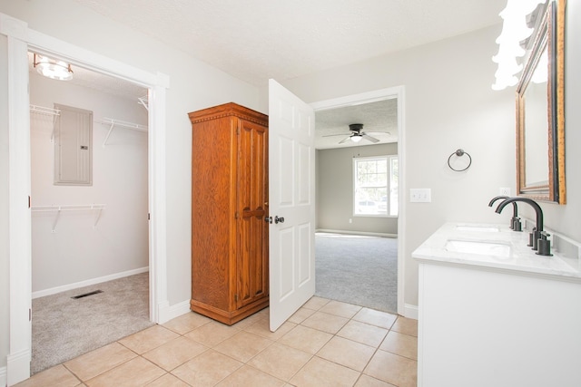 bathroom with electric panel, ceiling fan, tile patterned flooring, and a textured ceiling