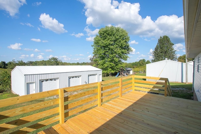 wooden terrace featuring an outbuilding and a garage