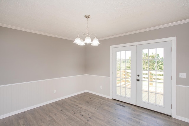 interior space featuring french doors, a textured ceiling, and hardwood / wood-style flooring