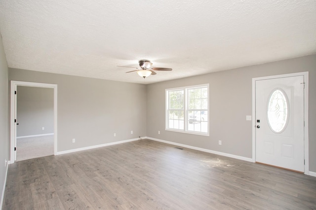 entrance foyer with ceiling fan, wood-type flooring, and a textured ceiling