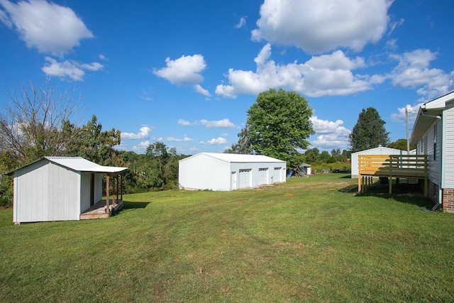 view of yard featuring a wooden deck and an outdoor structure