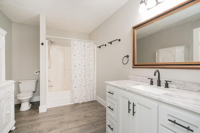 full bathroom featuring vanity, toilet, shower / bath combo with shower curtain, a textured ceiling, and wood-type flooring