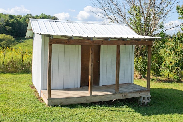 view of outbuilding with a yard