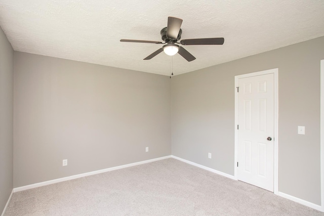 carpeted spare room with ceiling fan and a textured ceiling