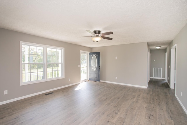 interior space with hardwood / wood-style flooring, ceiling fan, and a textured ceiling