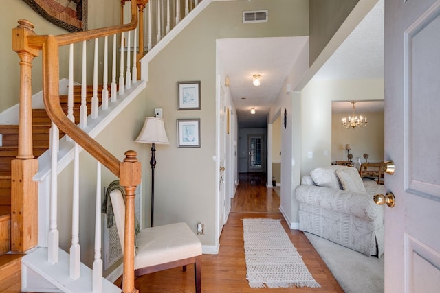 foyer with light wood-type flooring and an inviting chandelier