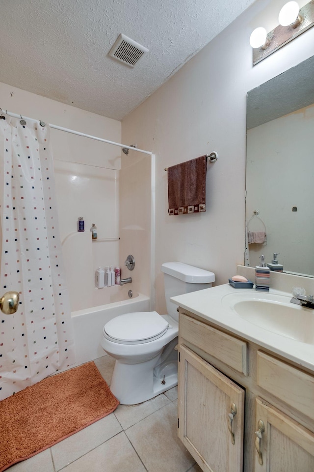 full bathroom with shower / bath combo, tile patterned flooring, a textured ceiling, toilet, and vanity