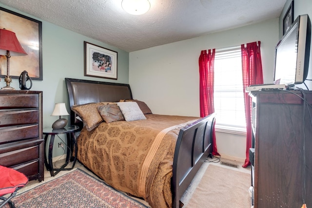 carpeted bedroom with a textured ceiling