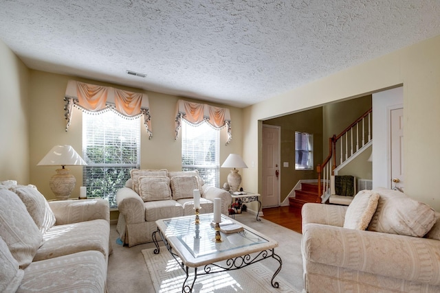 living room with hardwood / wood-style floors and a textured ceiling