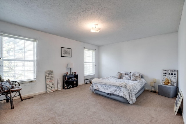 bedroom with carpet flooring and a textured ceiling