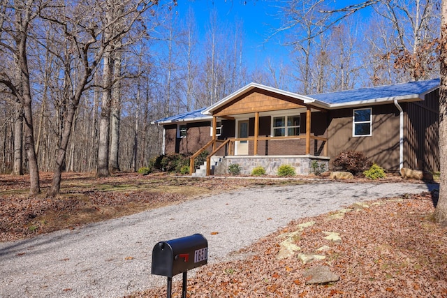 single story home featuring covered porch