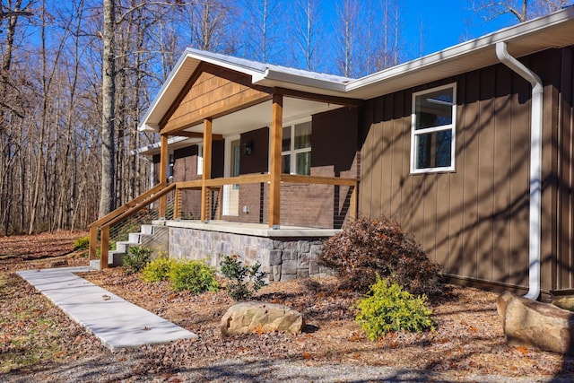 view of side of property with a porch