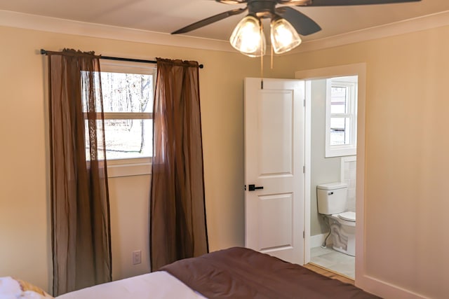 bedroom with connected bathroom, ceiling fan, and ornamental molding