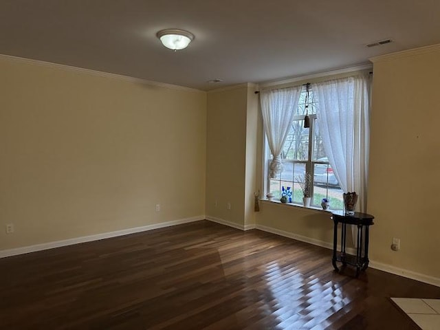 empty room with dark hardwood / wood-style floors and ornamental molding