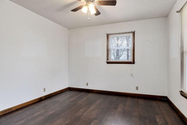 spare room with ceiling fan and dark wood-type flooring