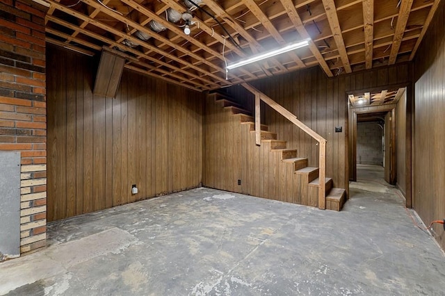 basement featuring wooden walls