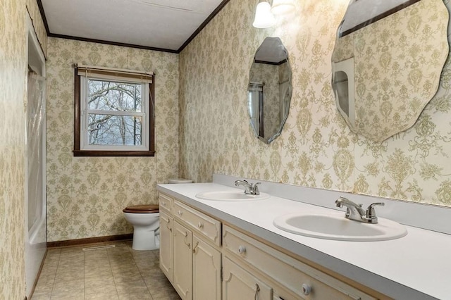 bathroom with vanity, toilet, tile patterned flooring, and ornamental molding