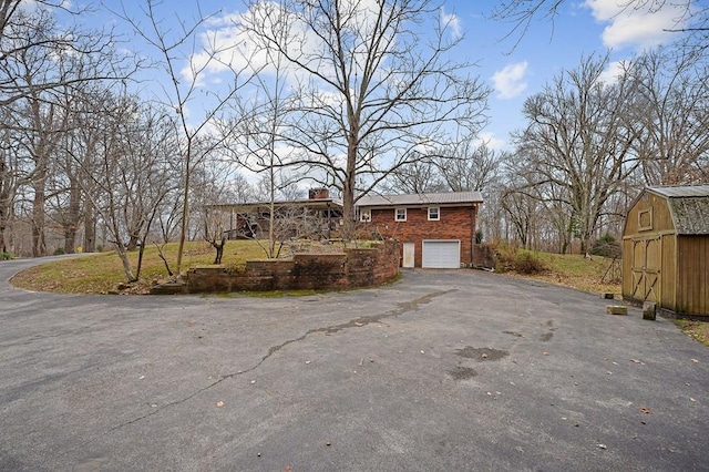 view of side of property featuring a shed and a garage