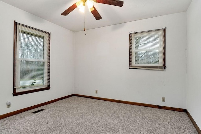 unfurnished room with carpet and ceiling fan