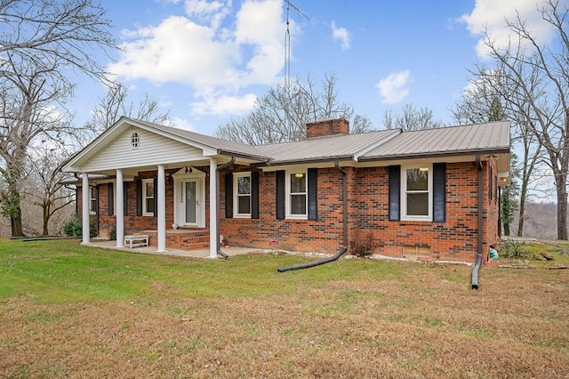 back of house featuring covered porch and a yard