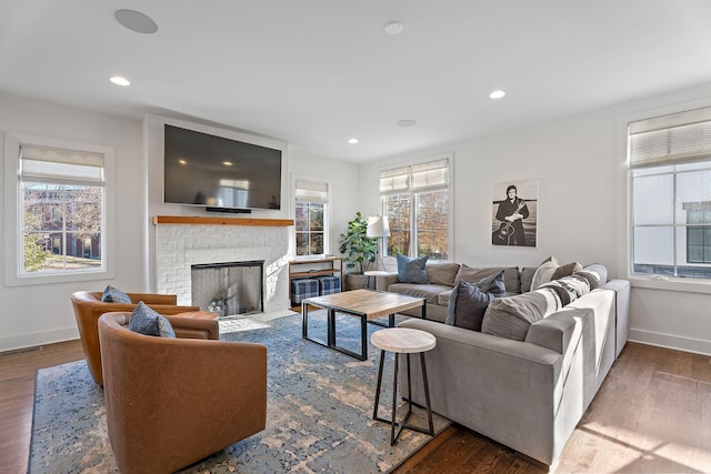 living room featuring a fireplace, hardwood / wood-style flooring, and a wealth of natural light