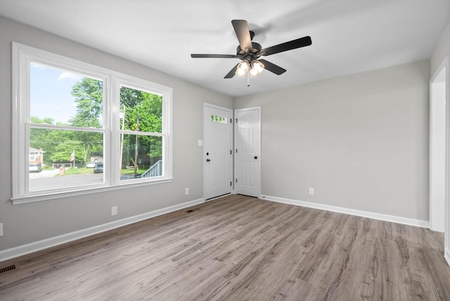 empty room featuring ceiling fan and light hardwood / wood-style floors