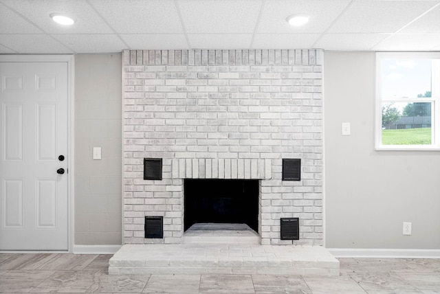 details featuring a paneled ceiling and a fireplace