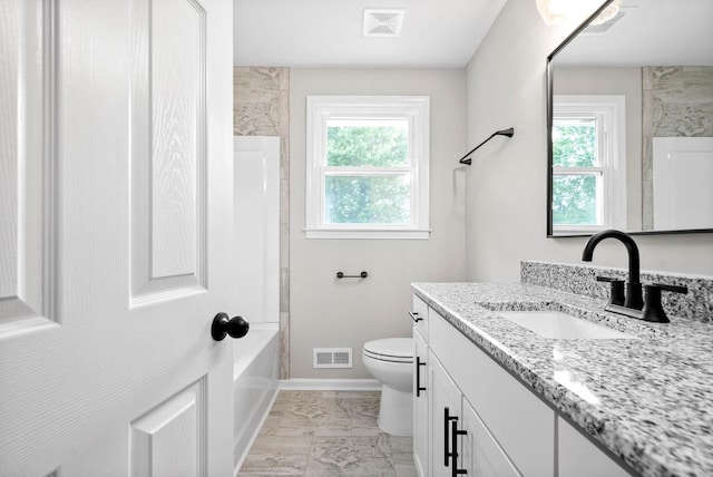 full bathroom featuring vanity, bathing tub / shower combination, toilet, and a healthy amount of sunlight