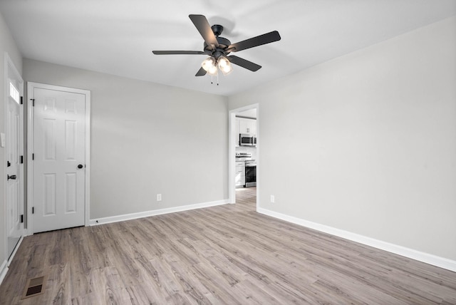 empty room with ceiling fan and light wood-type flooring