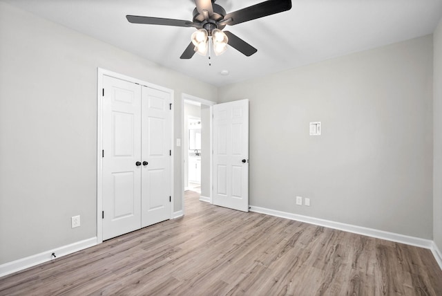 unfurnished bedroom featuring a closet, light hardwood / wood-style flooring, and ceiling fan