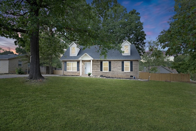 new england style home with a yard