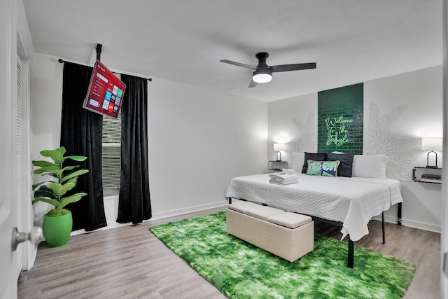 bedroom with hardwood / wood-style floors and ceiling fan