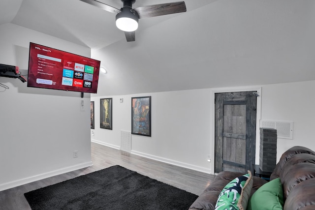 living room featuring wood-type flooring, vaulted ceiling, and ceiling fan