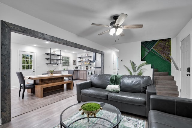 living room with ceiling fan and light hardwood / wood-style floors